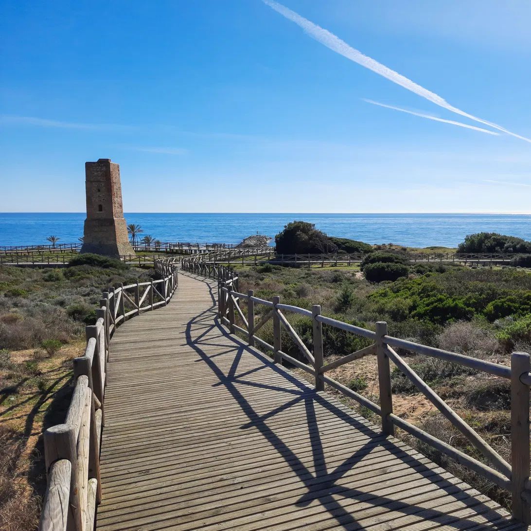 Wooden boardwalk through the protected Artola dunes