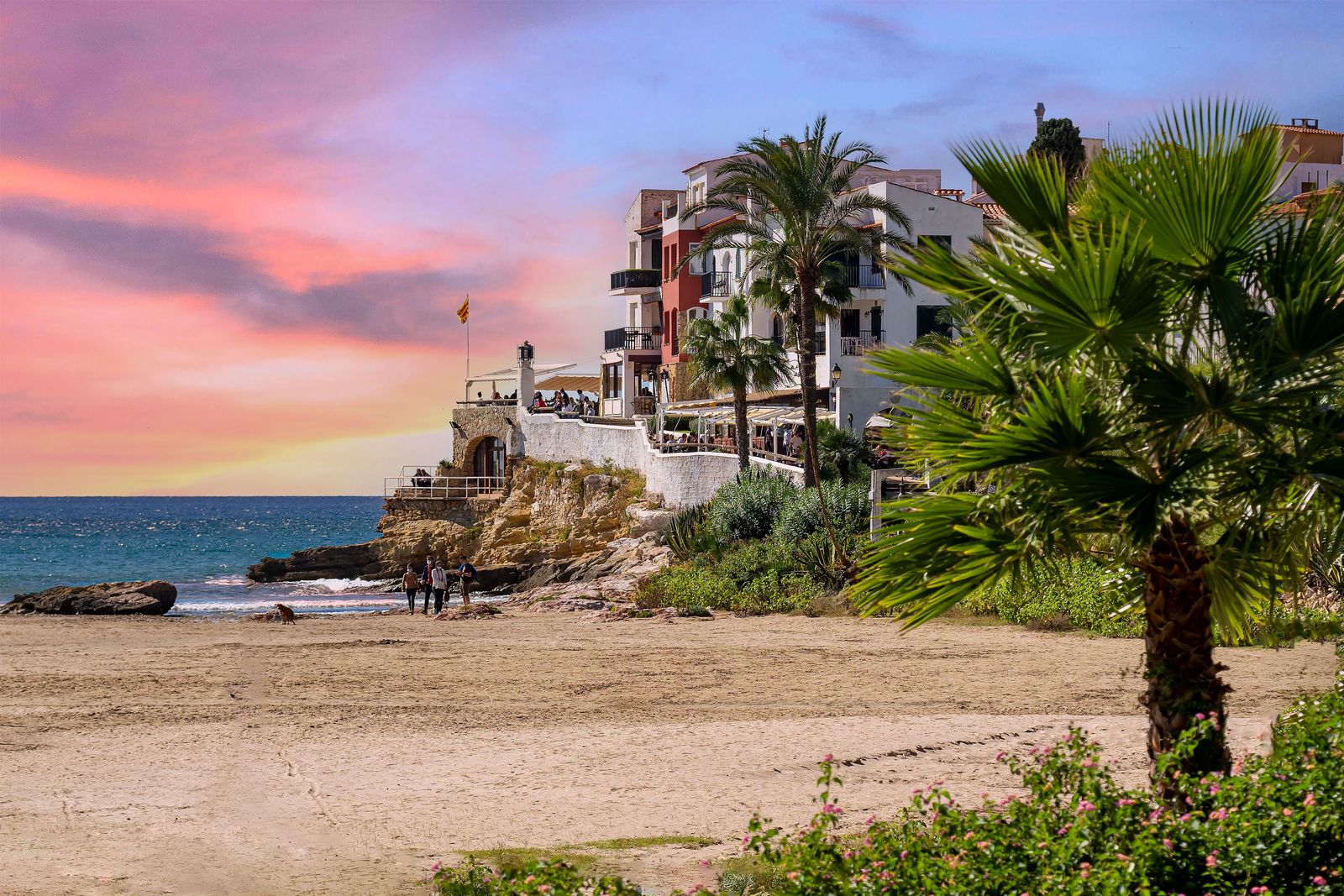 Sunset over Marbella with fortress and palm trees